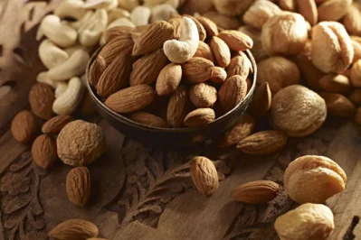 Any sort of nuts, especially almost and wallnuts  helps to cut off cholestrol.