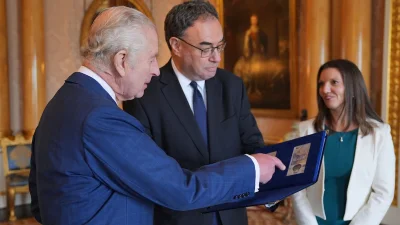 A folder displaying some of the new notes bearing a portrait of King Charles III